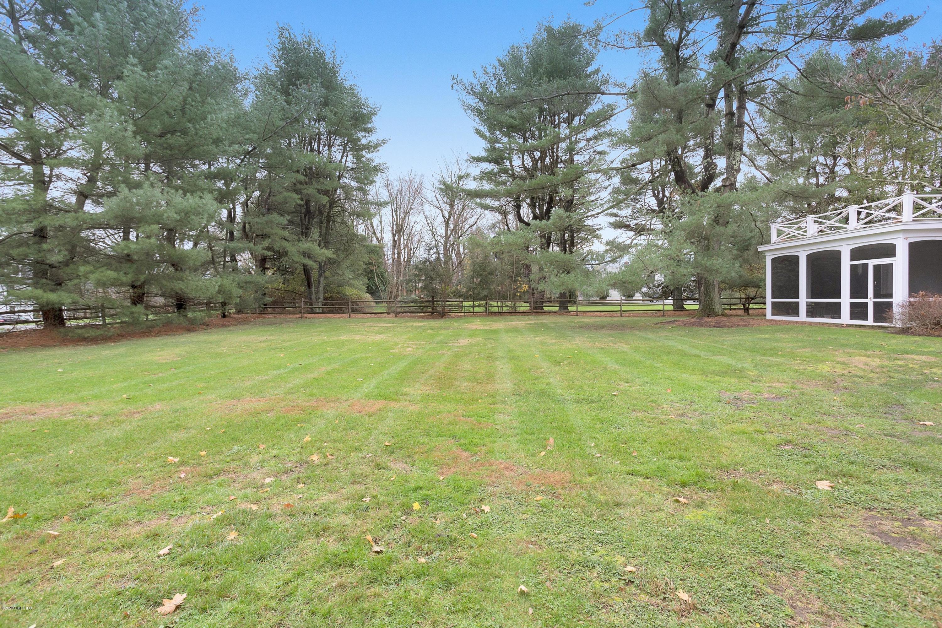 207 Round Hill Road Greenwich, CT 06831 - Photo 22 of 28 a view of a building with a yard