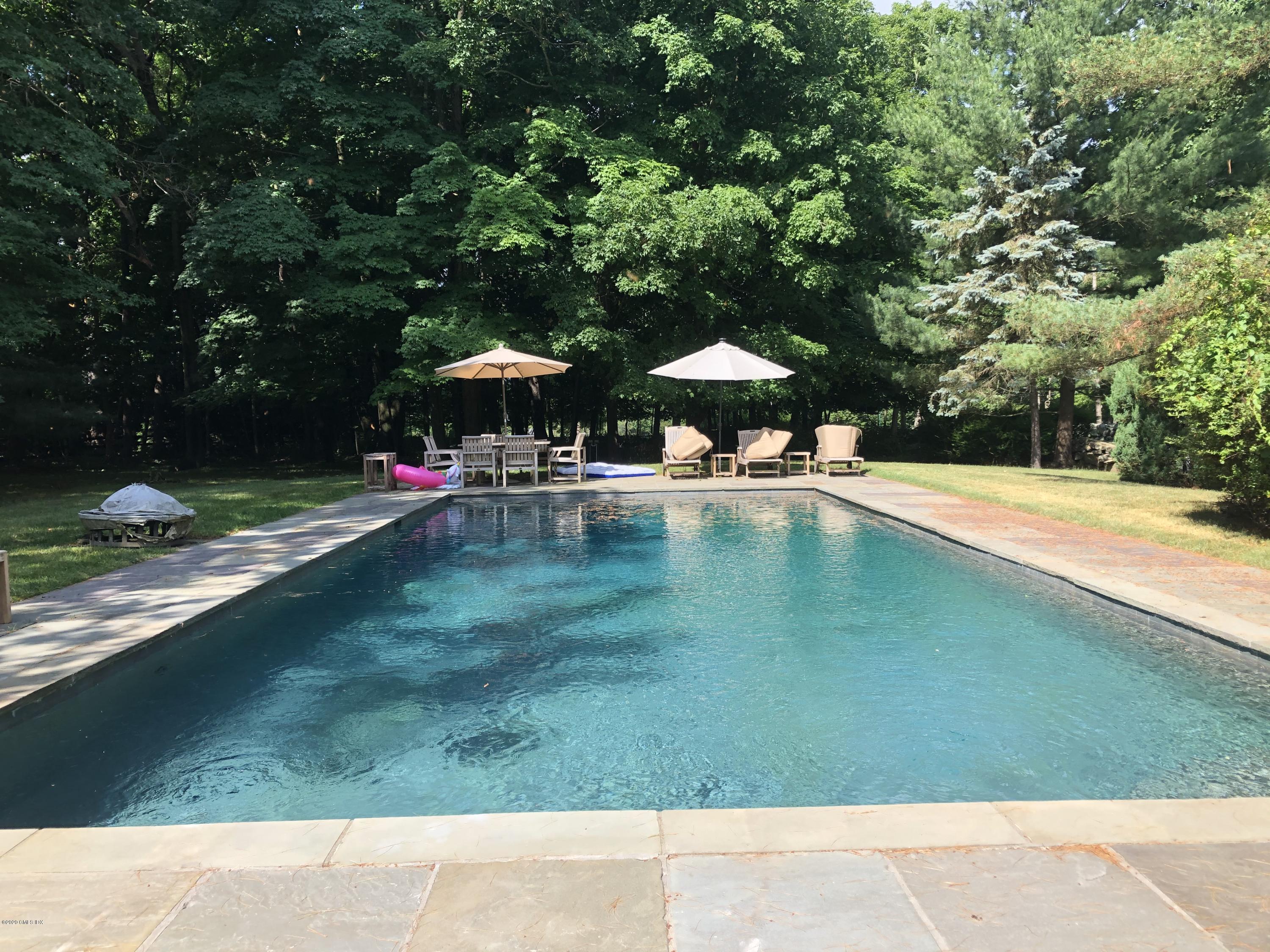 207 Round Hill Road Greenwich, CT 06831 - Photo 25 of 28 a view of a swimming pool with a yard