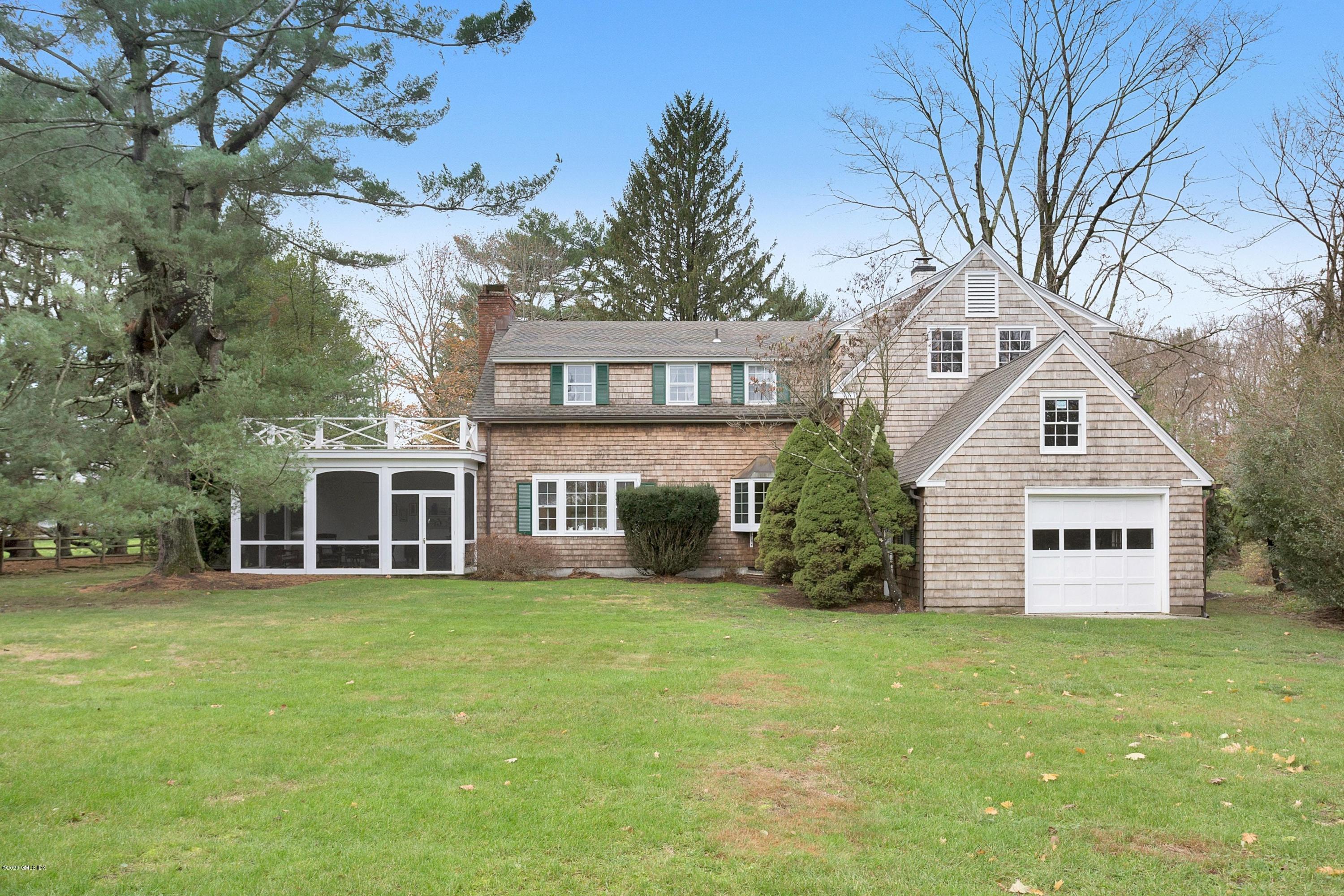 207 Round Hill Road Greenwich, CT 06831 - Photo 26 of 28 a view of a house with a yard and sitting area