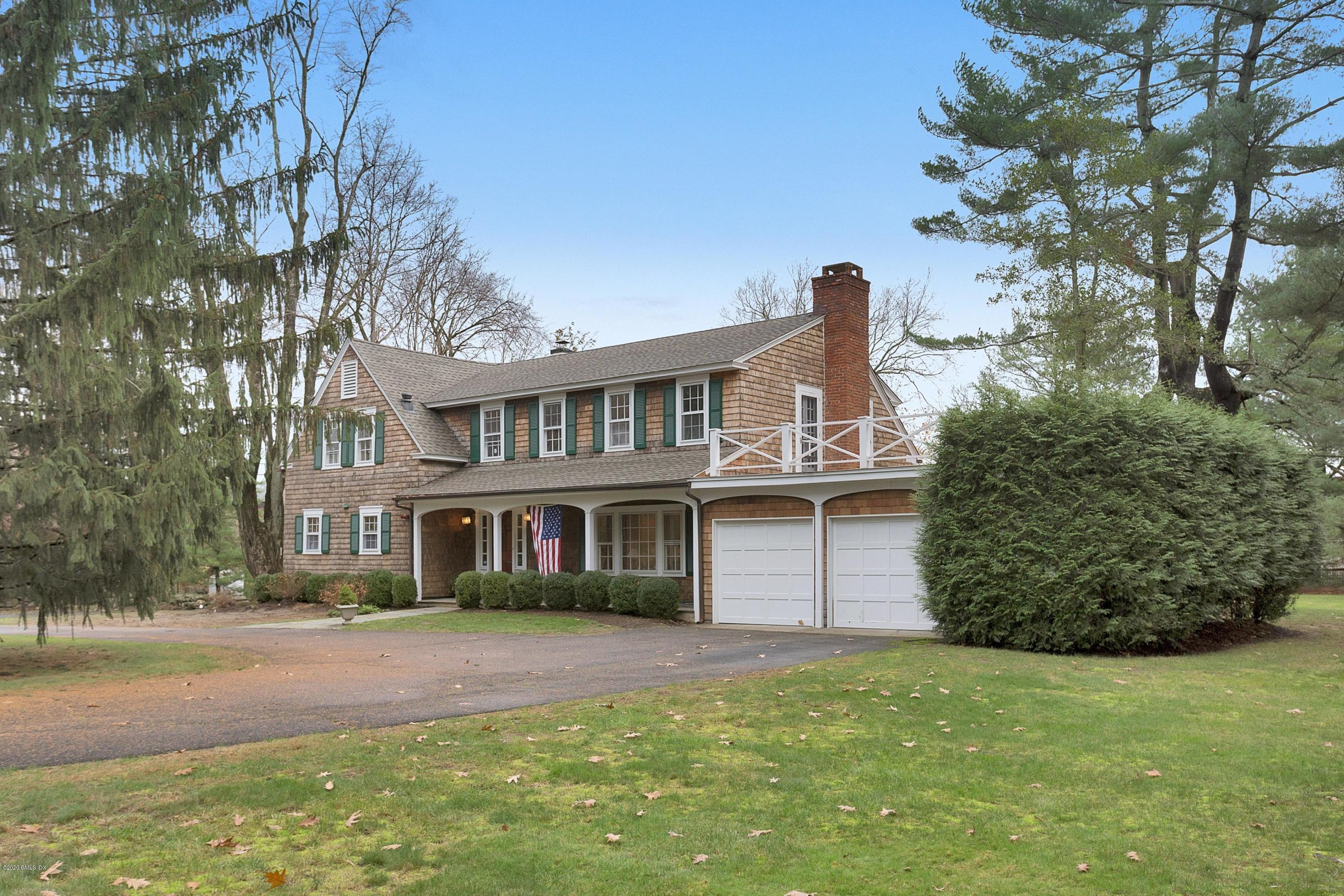 207 Round Hill Road Greenwich, CT 06831 - Photo 3 of 28 a front view of a house with garden