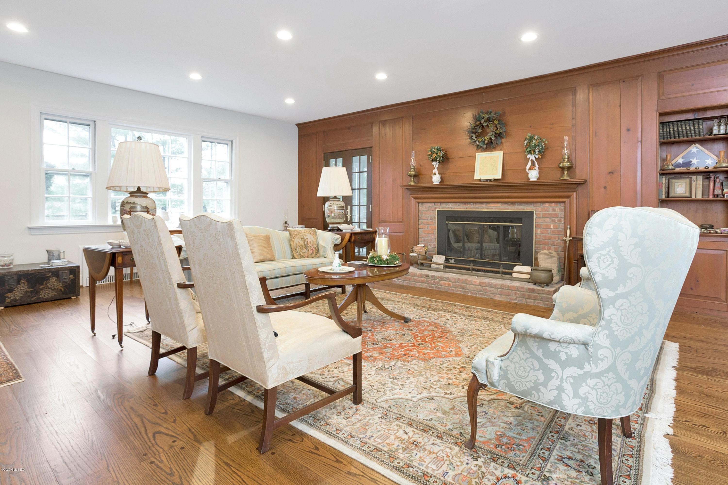207 Round Hill Road Greenwich, CT 06831 - Photo 6 of 28 a living room with fireplace furniture and a floor to ceiling window