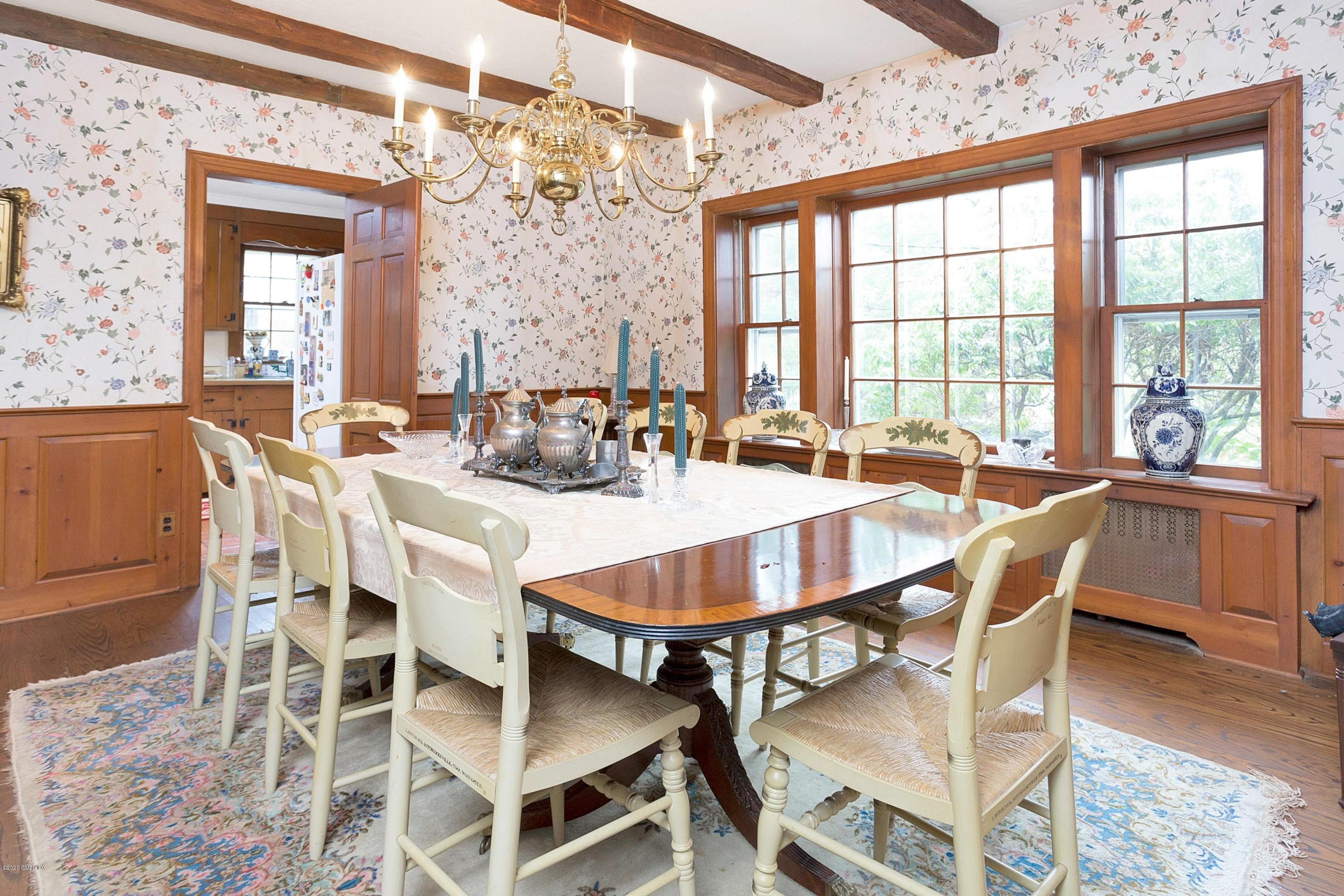 207 Round Hill Road Greenwich, CT 06831 - Photo 9 of 28 a dining room with furniture a chandelier and wooden floor