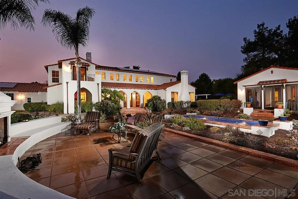 a view of a house with backyard patio and swimming pool