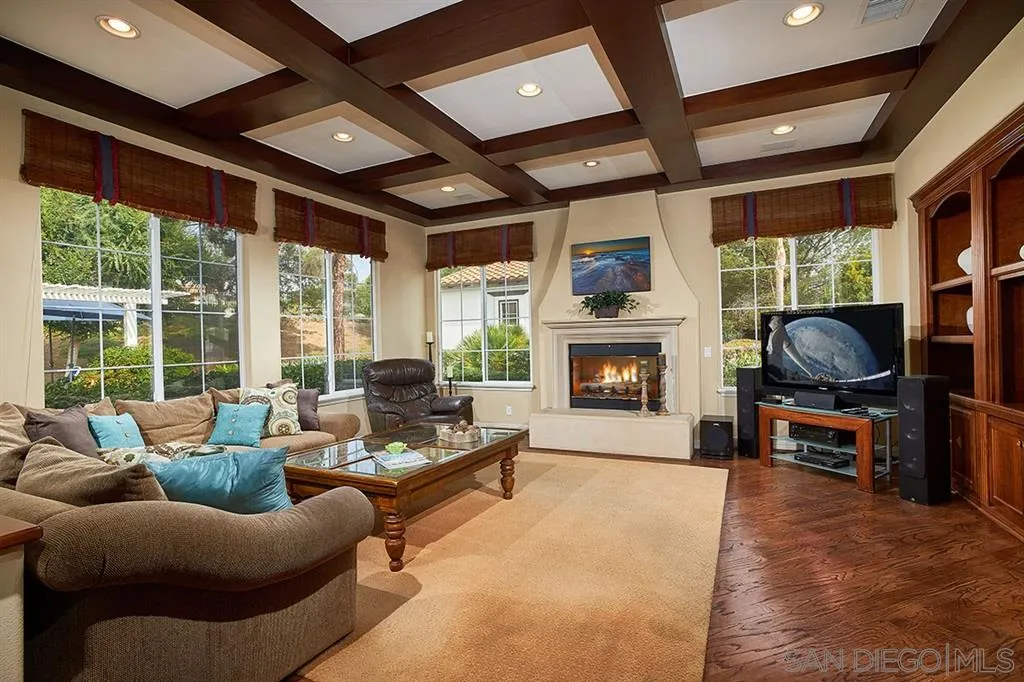 13625 Ash Hollow Crossing Road Poway, CA 92064 - Photo 11 of 25 a living room with furniture a fireplace and a flat screen tv