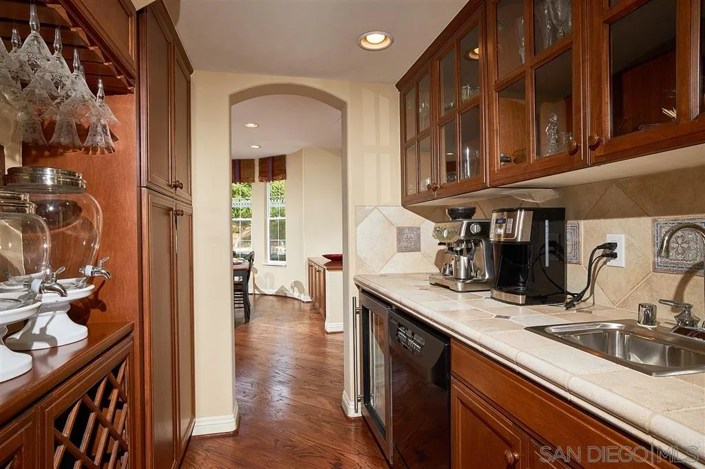 13625 Ash Hollow Crossing Road Poway, CA 92064 - Photo 13 of 25 a kitchen with stainless steel appliances granite countertop a sink and cabinets