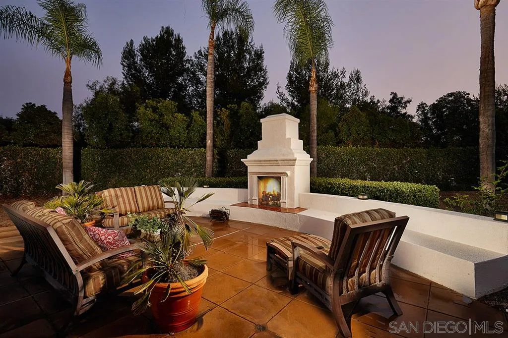 13625 Ash Hollow Crossing Road Poway, CA 92064 - Photo 21 of 25 a view of a patio with couches table and chairs with wooden floor and fence