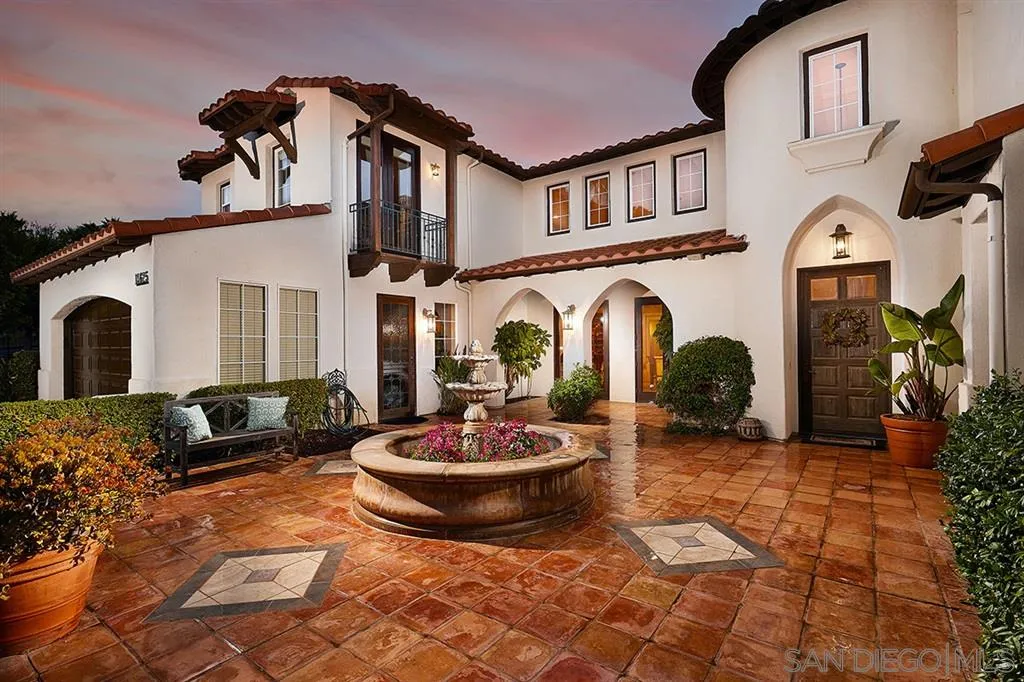 13625 Ash Hollow Crossing Road Poway, CA 92064 - Photo 4 of 25 a view of a white building with couches potted plants and a fireplace