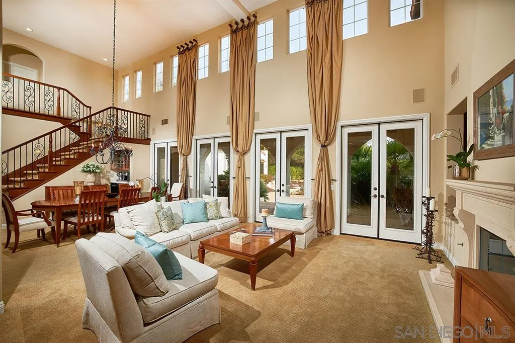 13625 Ash Hollow Crossing Road Poway, CA 92064 - Photo 6 of 25 a living room with furniture fireplace and a chandelier