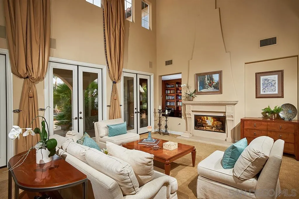 13625 Ash Hollow Crossing Road Poway, CA 92064 - Photo 7 of 25 a living room with furniture a fireplace and a flat screen tv