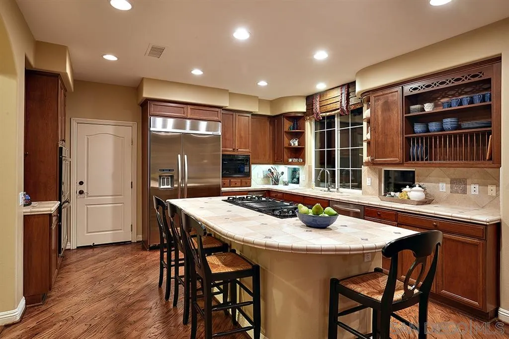 13625 Ash Hollow Crossing Road Poway, CA 92064 - Photo 8 of 25 a kitchen with a table and chairs in it