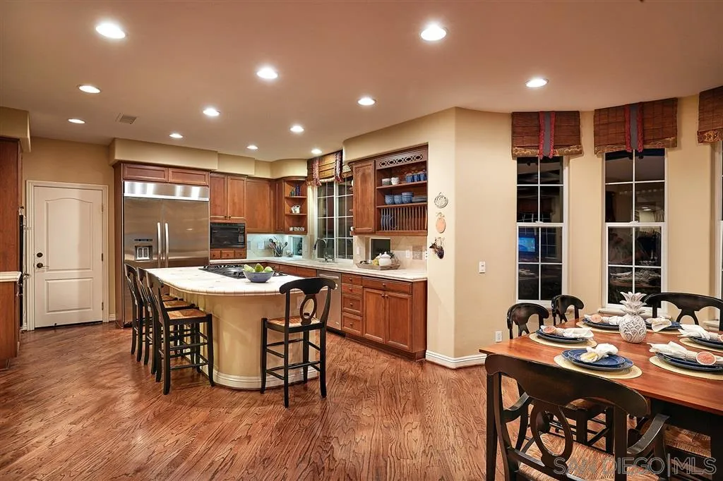 13625 Ash Hollow Crossing Road Poway, CA 92064 - Photo 9 of 25 a kitchen with a table and chairs in it