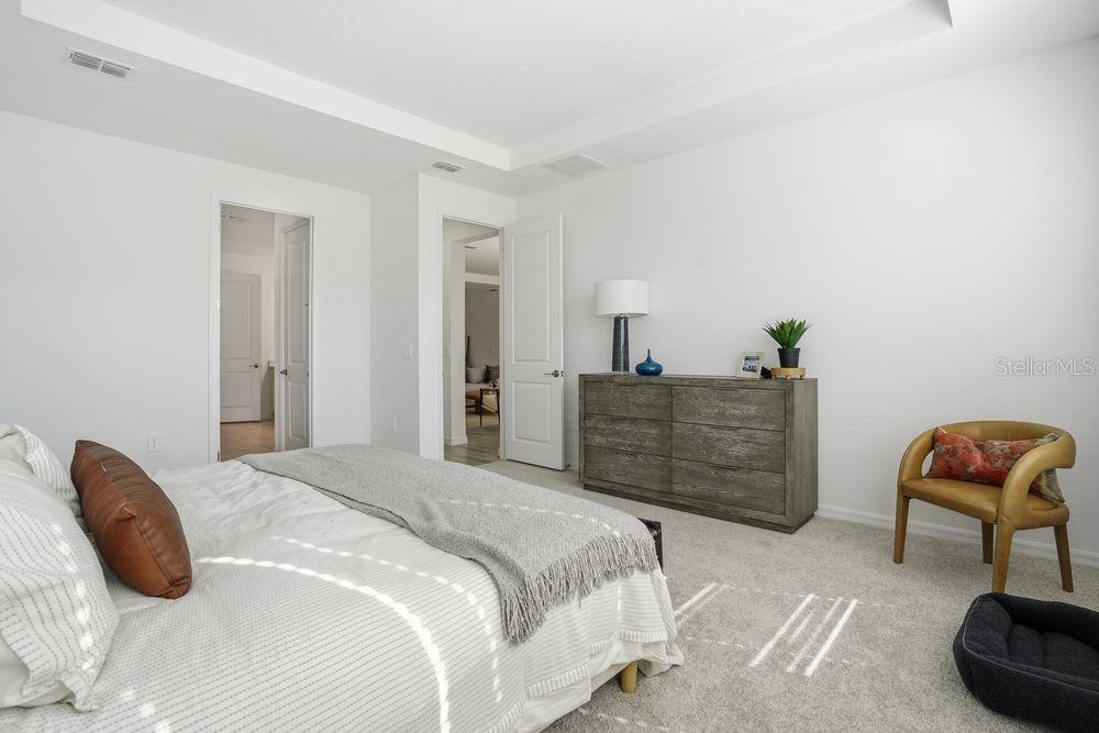 14242 Sawmill Street Parrish, FL 34219 - Photo 15 of 41 a bedroom with a bed and a chair