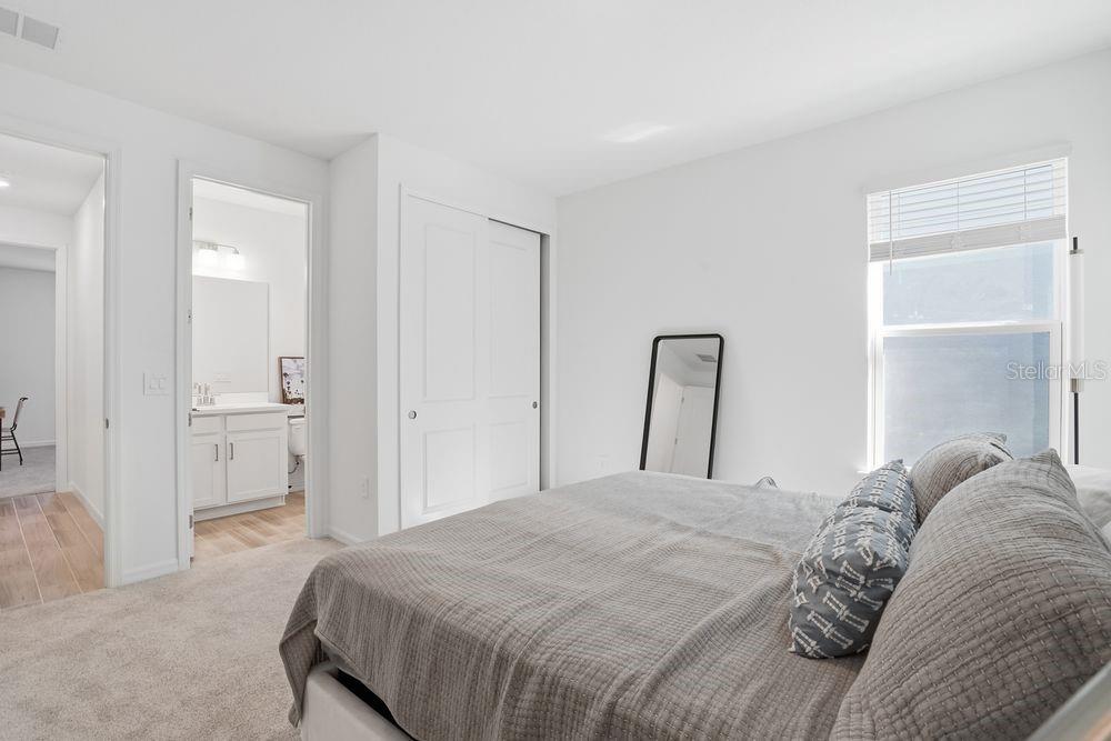 14242 Sawmill Street Parrish, FL 34219 - Photo 21 of 41 a bedroom with a bed and a mirror