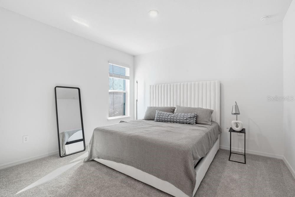 14242 Sawmill Street Parrish, FL 34219 - Photo 22 of 41 a bedroom with a bed and a mirror