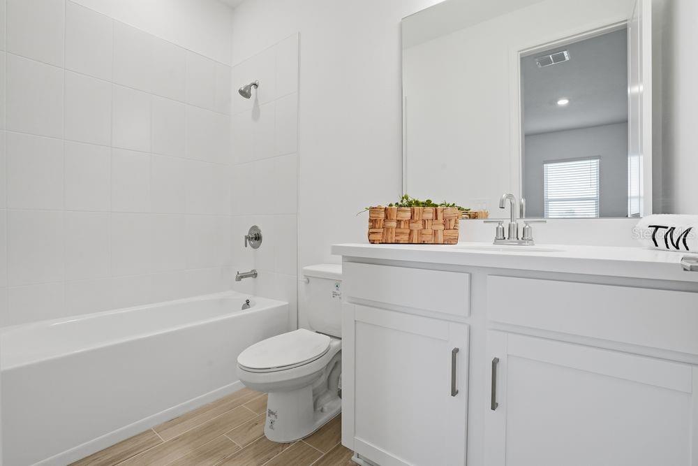 14242 Sawmill Street Parrish, FL 34219 - Photo 25 of 41 a bathroom with a sink a toilet and a bathtub