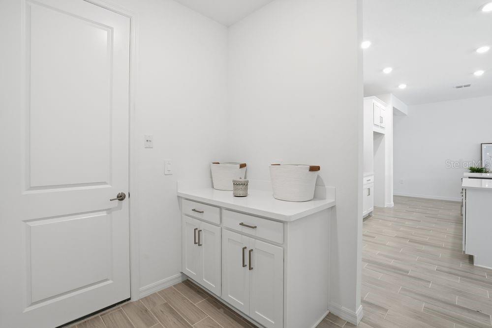 14242 Sawmill Street Parrish, FL 34219 - Photo 32 of 41 a view of a hallway with closet and wooden floor