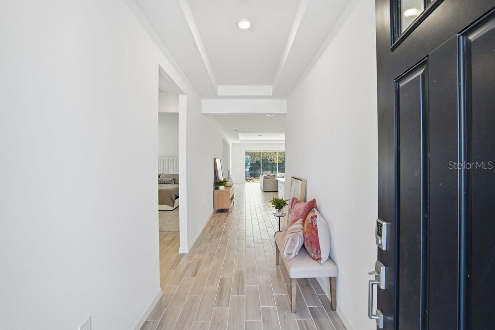 14242 Sawmill Street Parrish, FL 34219 - Photo 33 of 41 a view of a hallway with furniture and wooden floor