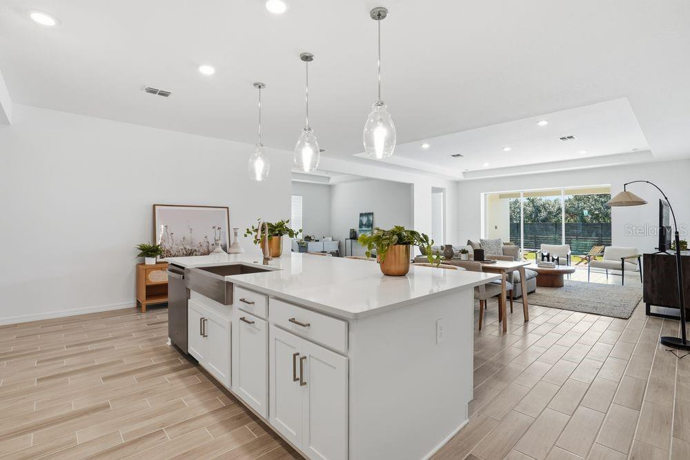 14242 Sawmill Street Parrish, FL 34219 - Photo 7 of 41 a large kitchen with kitchen island a wooden floor