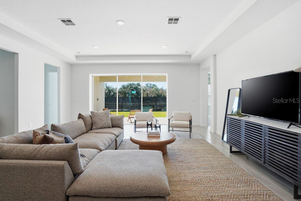 14242 Sawmill Street Parrish, FL 34219 - Photo 9 of 41 a living room with furniture and a flat screen tv