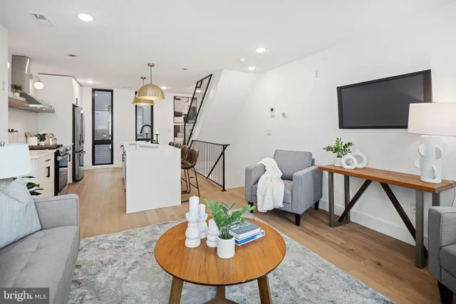 a view of staircase with lots of frames on wall