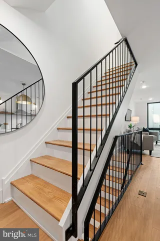 a bedroom with a bed and large windows