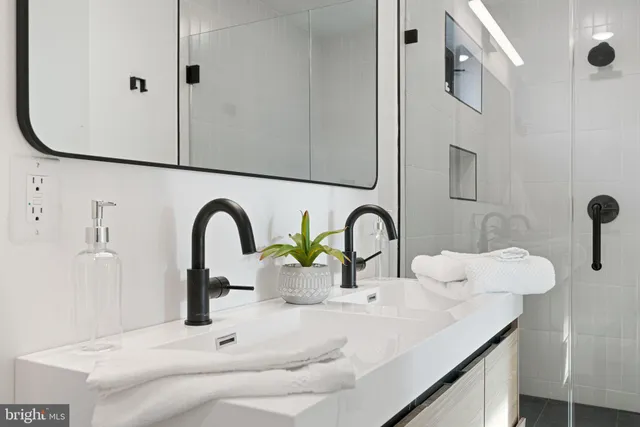 a spacious bedroom with a bed and glass windows