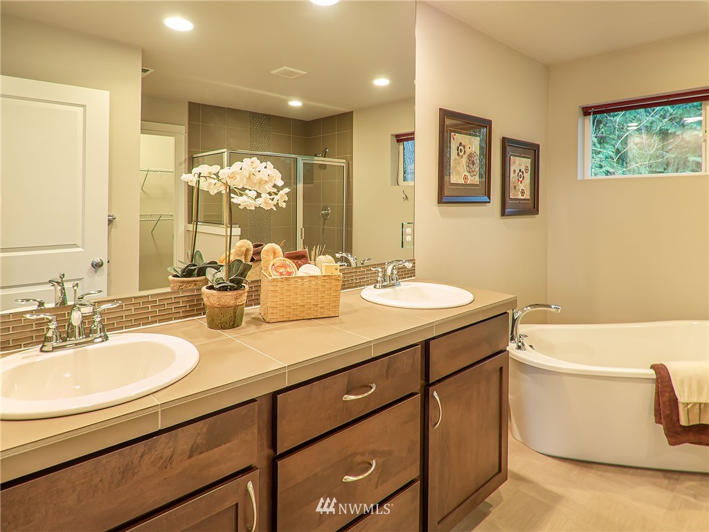 415 161st Place Southeast Bothell, WA 98012 - Photo 14 of 28 a bathroom with a double vanity sink a mirror and a bathtub
