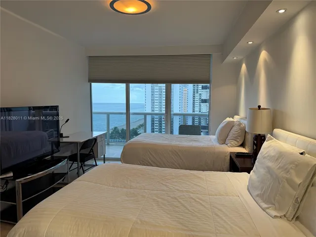 a bedroom with a bed and a night stand