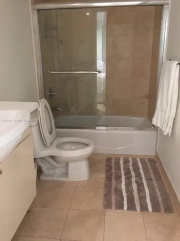 a bathroom with a sink toilet and a mirror