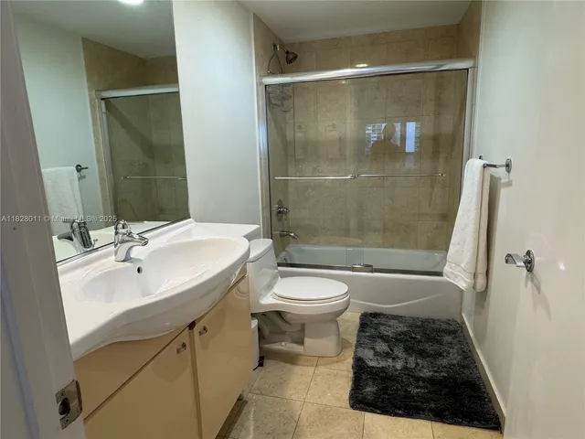 a bathroom with a sink a mirror and shower