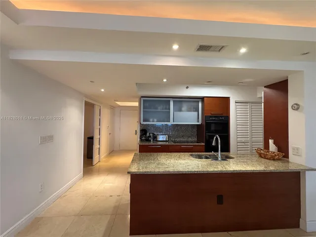 a kitchen with stainless steel appliances granite countertop a stove and a sink