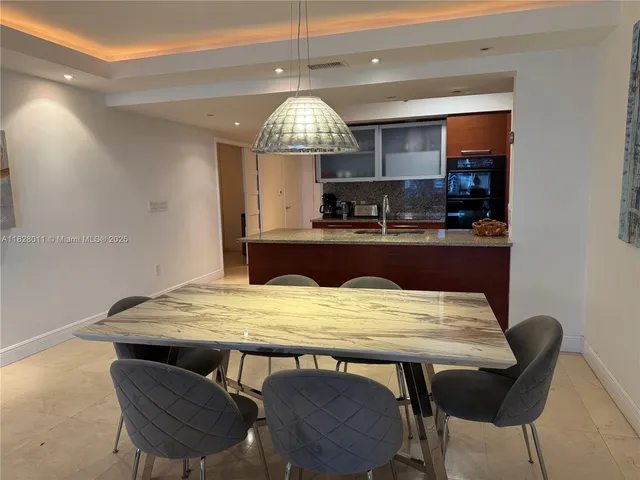 a kitchen with a table chairs and a refrigerator
