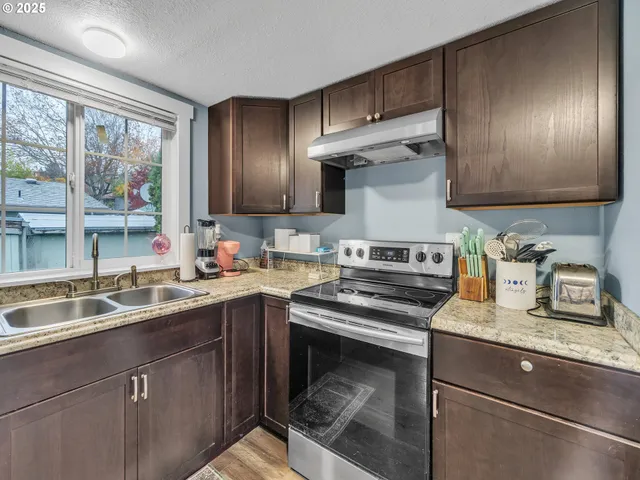 a kitchen with a sink stove and cabinets