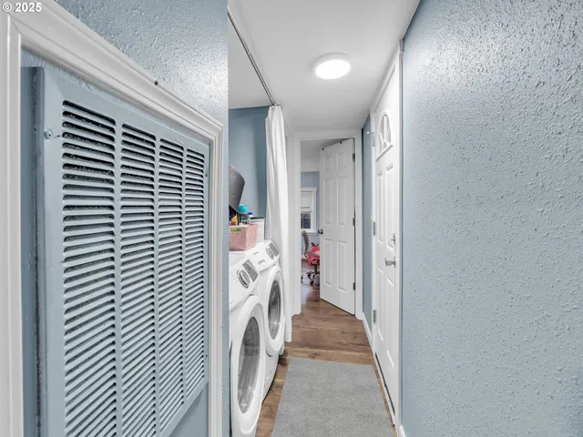a view of a hallway with washer and dryer