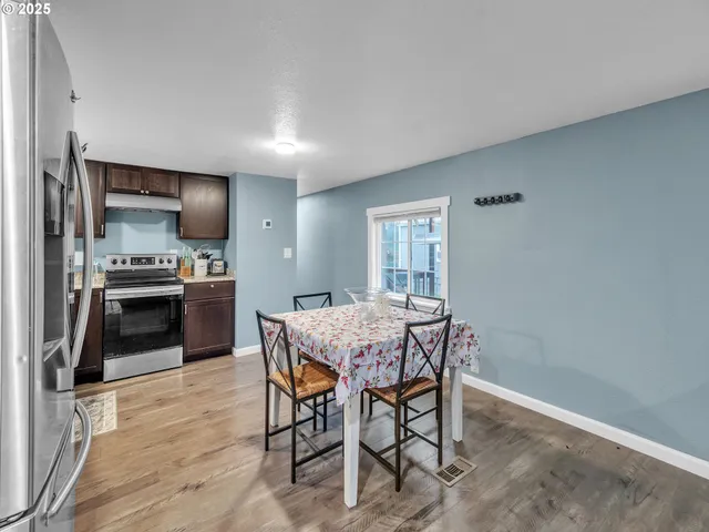 a view of a dining room with furniture and wooden floor