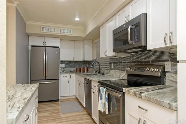 a kitchen with a refrigerator stove and microwave