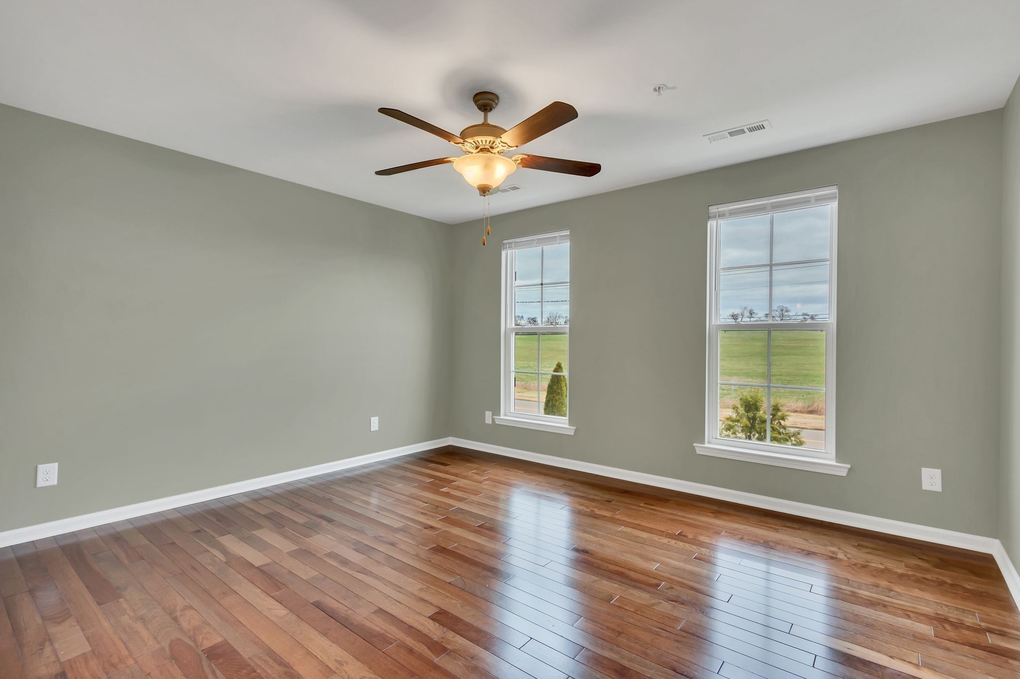 305 Dursley Lane Spring Hill, TN 37174 - Photo 13 of 25 a view of an empty room with window and wooden floor