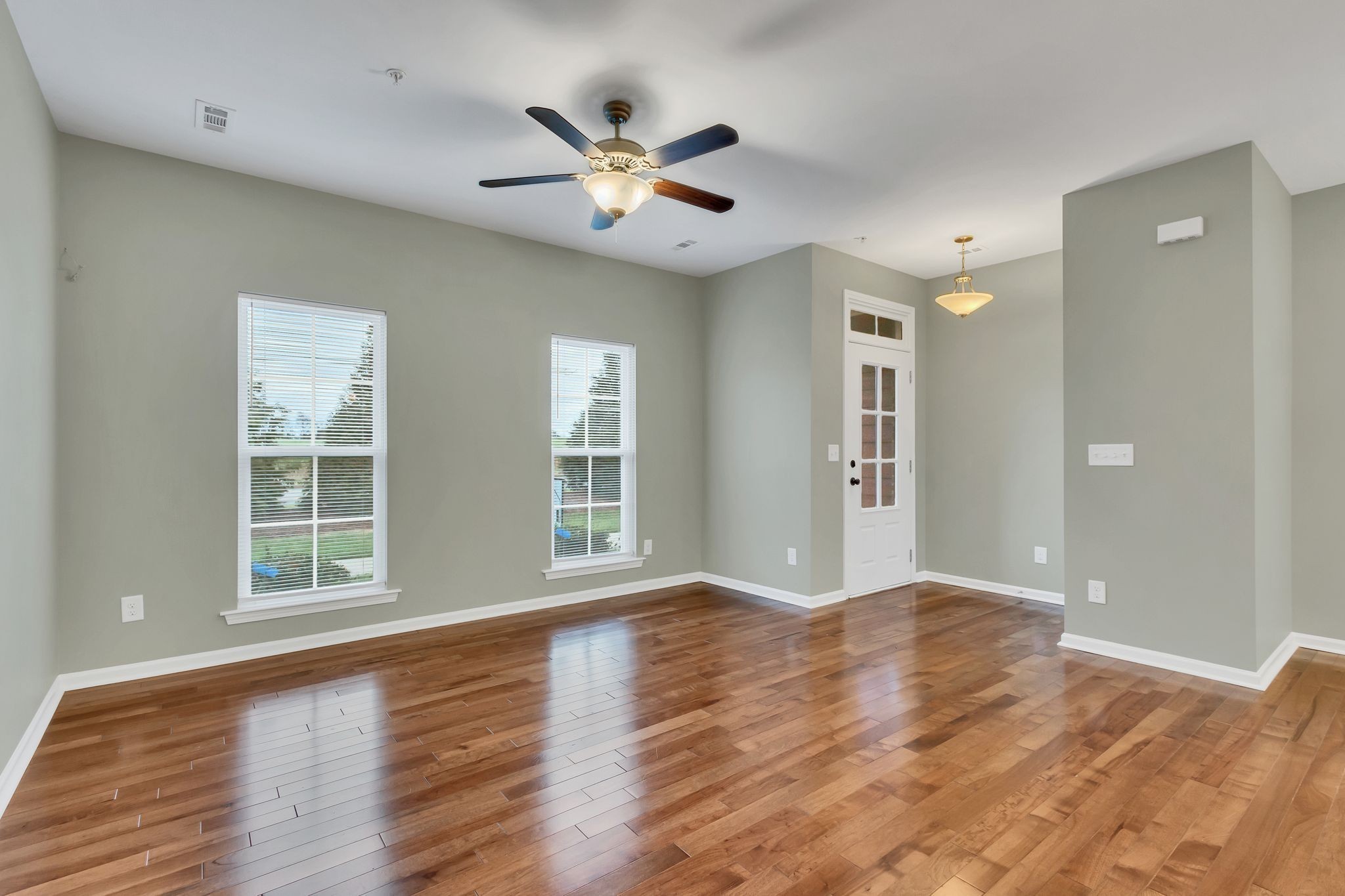 305 Dursley Lane Spring Hill, TN 37174 - Photo 6 of 25 a view of an empty room with a window and wooden floor