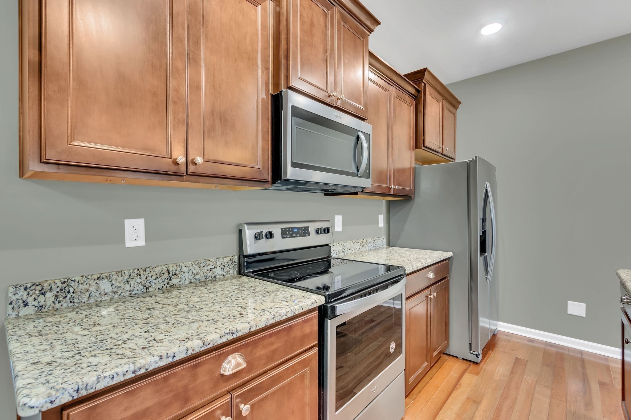 305 Dursley Lane Spring Hill, TN 37174 - Photo 10 of 25 a kitchen with stainless steel appliances granite countertop a stove a sink and a microwave