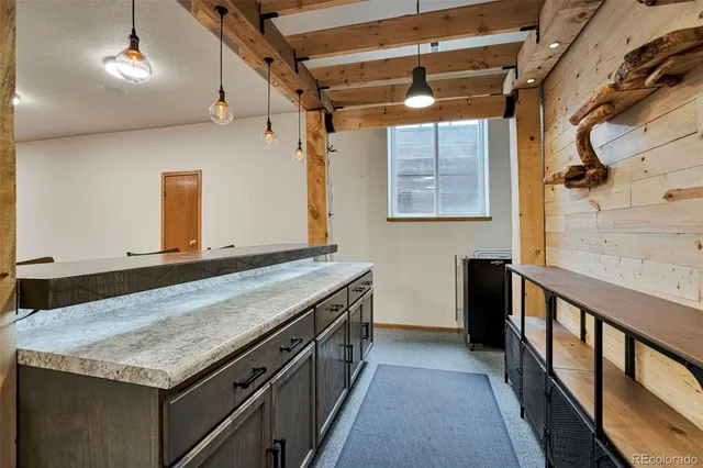 a bathroom with a granite countertop sink and a large mirror