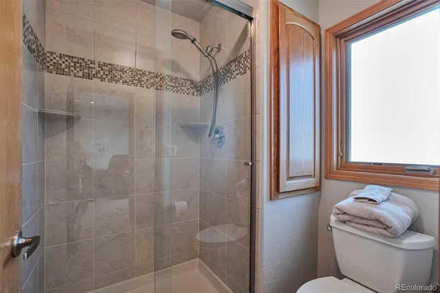 a bathroom with a toilet and shower