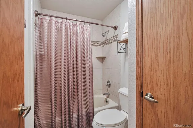 a bathroom with a toilet a sink and shower