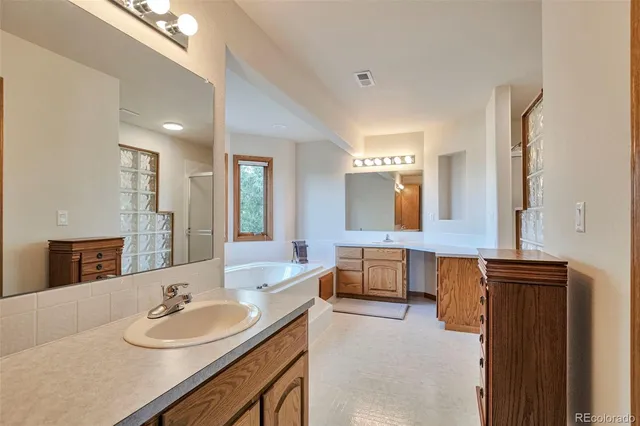 a bathroom with a double vanity sink and a mirror