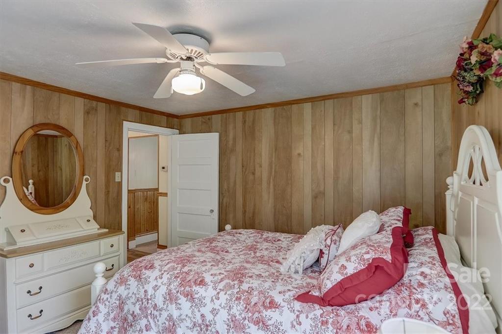 115 Substation Road Canton, NC 28716 - Photo 20 of 41 a bedroom with a bed and a chandelier