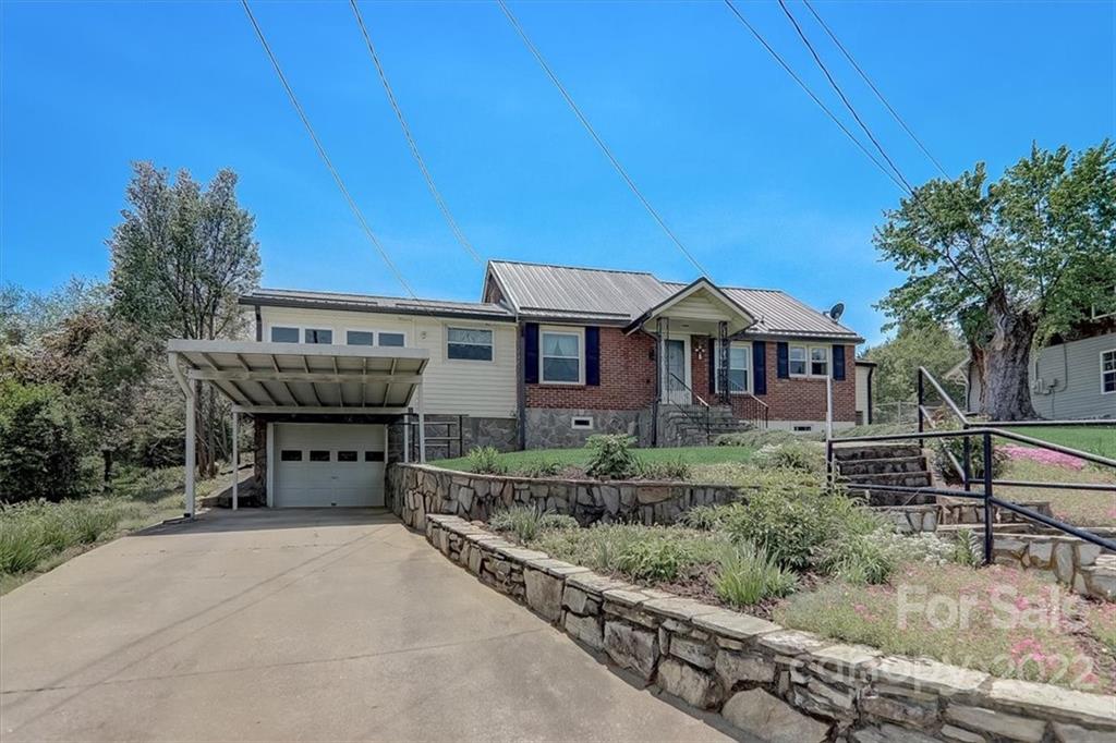 115 Substation Road Canton, NC 28716 - Photo 2 of 41 a front view of a house with a garden
