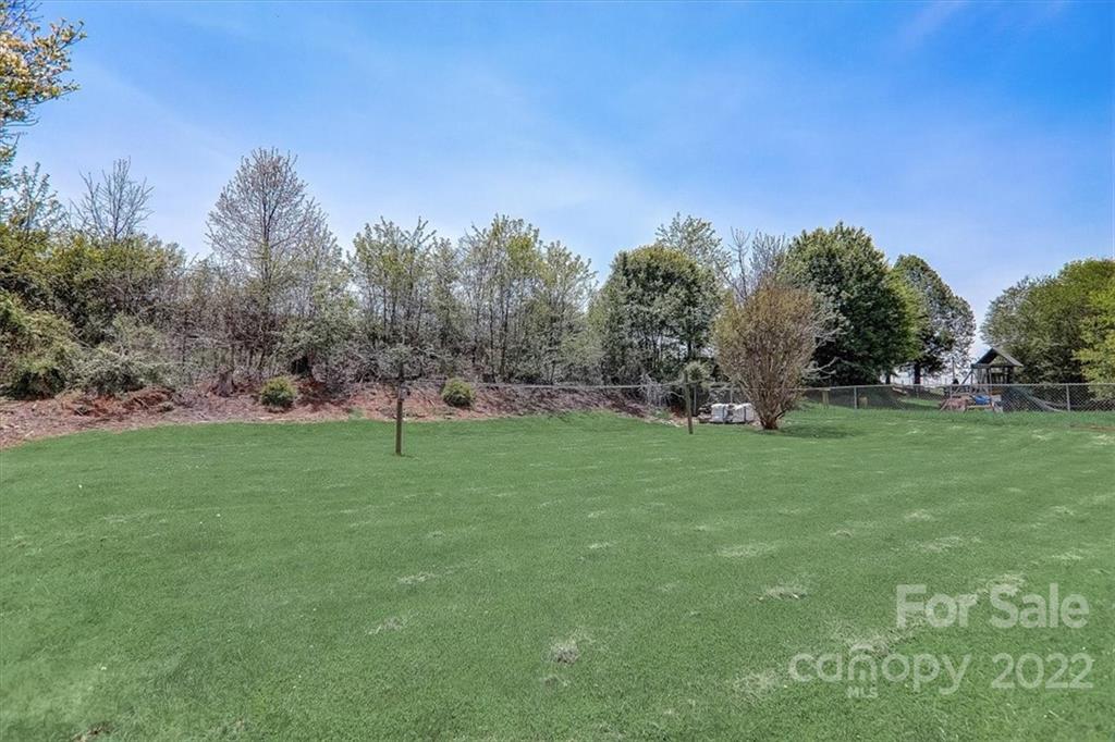 115 Substation Road Canton, NC 28716 - Photo 4 of 41 a view of a field with trees in the background
