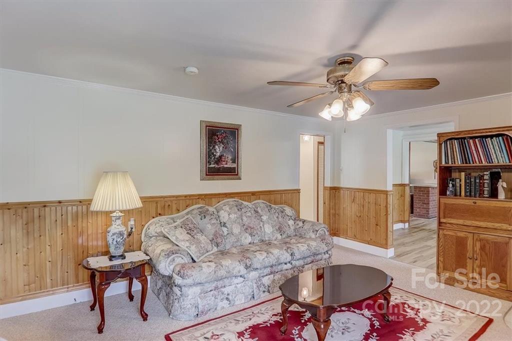 115 Substation Road Canton, NC 28716 - Photo 6 of 41 a living room with furniture and a book shelf