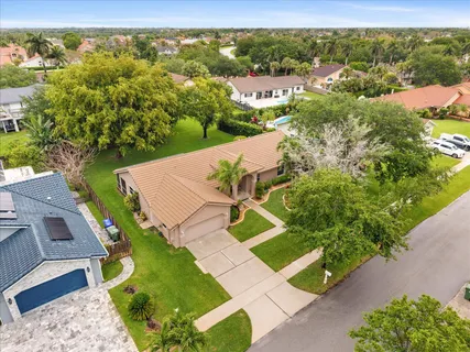an aerial view of a house with a yard