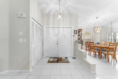 a view of a dining room with furniture and chandelier