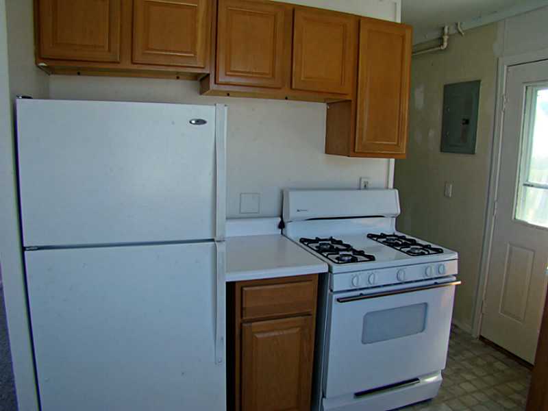 11 Ludlow Road Middletown, RI 02842 - Photo 3 of 24 Kitchen. 1 Bedroom Unit Kitchen. Side door and beyond is utility/laundry room